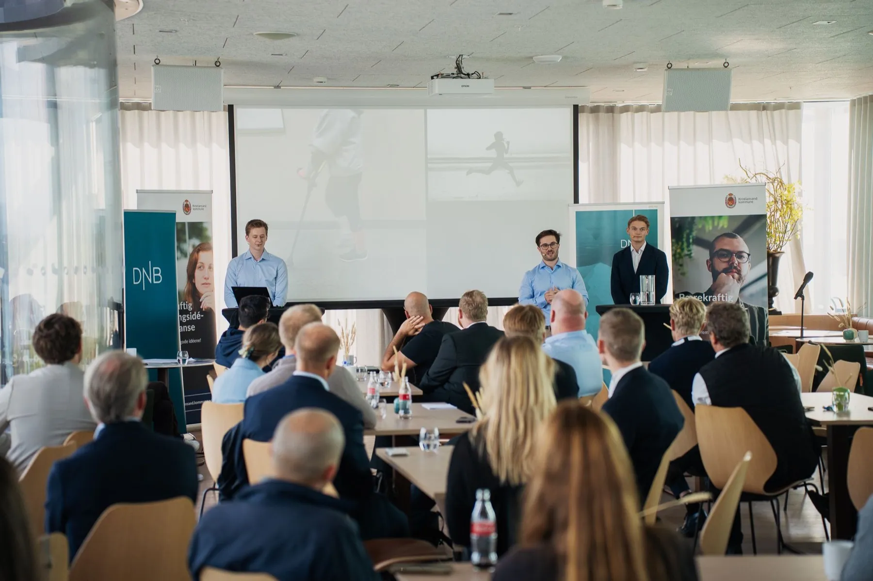 The NeuroFlex Robotics team presenting to an audience at an event